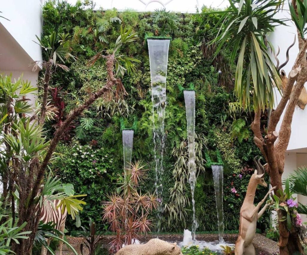 Jardín vertical exterior con cascadas de agua integradas entre la vegetación